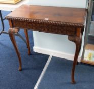 A polished mahogany fold over tea table on cabriole legs with carved frieze, width 77cm.