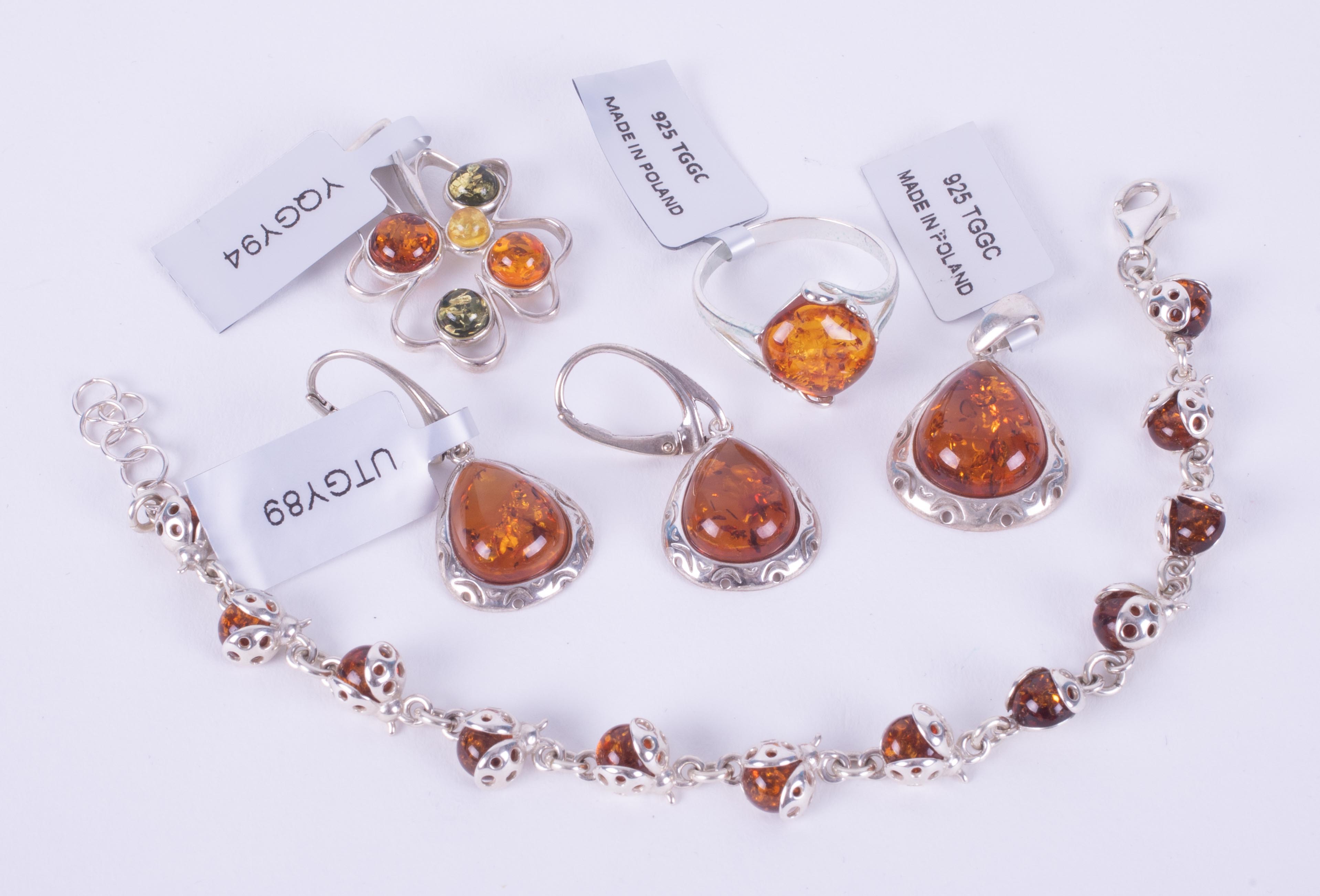 A collection of five pieces of silver amber set jewellery to include a pendant set with Baltic