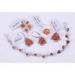 A collection of five pieces of silver amber set jewellery to include a pendant set with Baltic