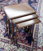 An Edwardian mahogany and inlaid nest of three tables.