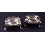 A pair of Georgian silver table salts of circular form, each on three feet, approximately 3.05oz, (