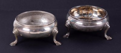 A pair of Georgian silver table salts of circular form, each on three feet, approximately 3.05oz, (