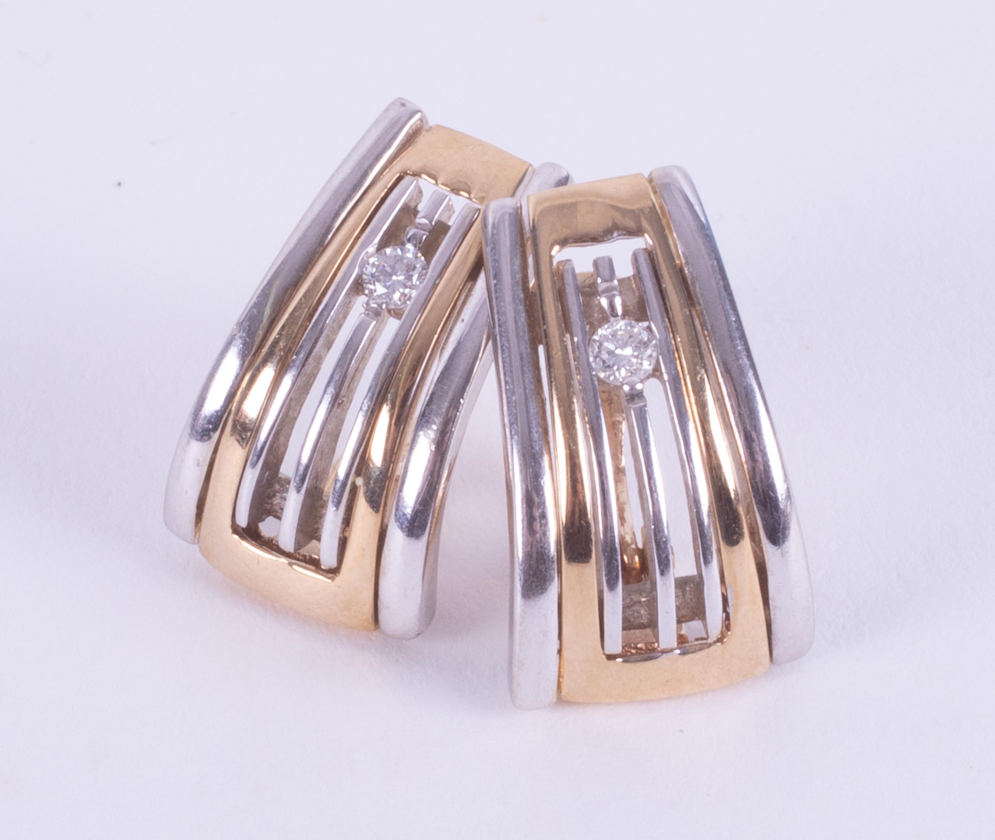 A pair of 9ct yellow & white gold curved design stud earrings set with approx. 0.14 carats total