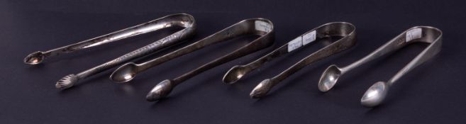 A pair of George III Dublin silver sugar tongs circa 1791 possibly by Benjamin Tait, another