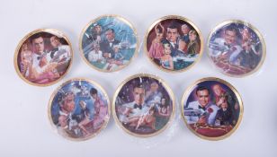 Seven James Bond limited edition Franklin Mint collectors plates, boxed with certificates and