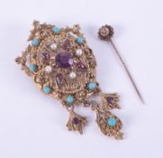 An ornate costume jewellery brooch/pendant set with faux stones and a 15ct yellow gold stick pin,