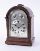 An oak cased bracket clock with chiming movement, height 35cm.