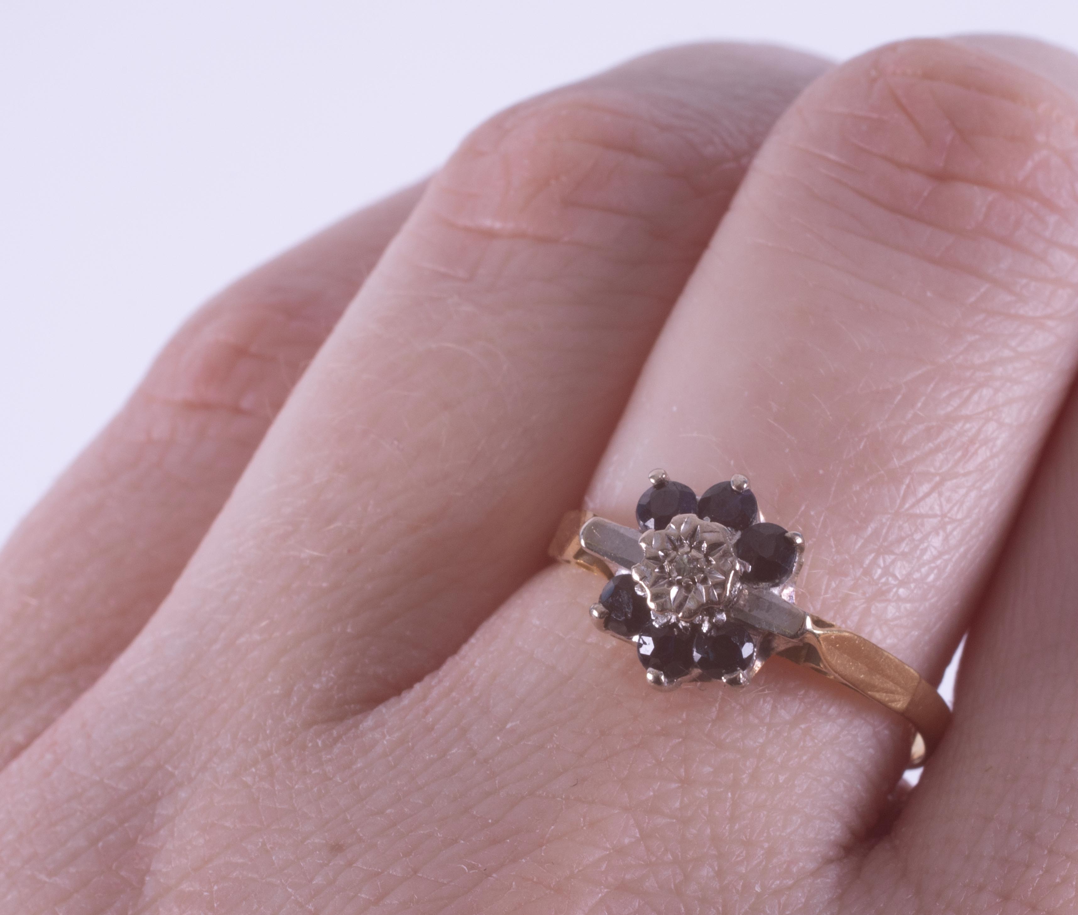 An 18ct yellow gold flower design ring set with round cut dark blue sapphires & a small - Image 2 of 2