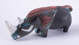 A ceramic art pottery model of a rhino, impress porcupine, length 29cm.