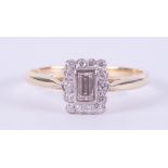 An 18ct yellow & white gold ring set with a central emerald cut diamond, approx. 0.25 carats,