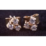 A pair of 18ct yellow gold trefoil design stud earrings set with round brilliant cut diamonds, total