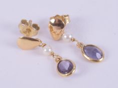 A pair of 18ct yellow gold drop earrings each set with an oval cut tanzanite, total weight of