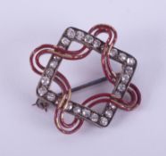 A yellow & white metal Art Deco geometric style antique brooch (not hallmarked or tested) with red