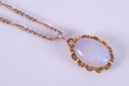 A yellow gold (not hallmarked or tested) antique oval pendant set with a cabochon cut white opal