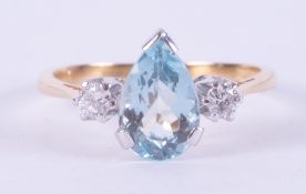 An 18ct yellow & white gold ring set with a central pear cut aquamarine, approx. 1.52 carats, with a