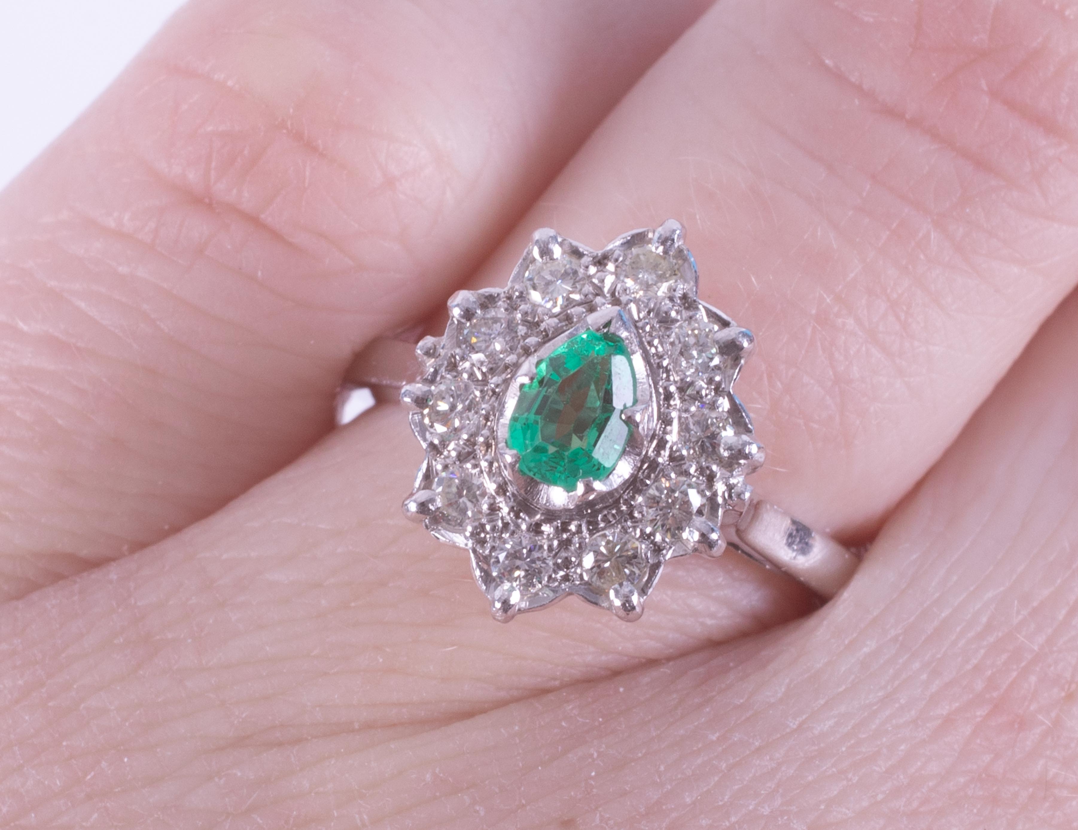 An 18ct white gold cluster style ring set with a central pear cut emerald, approx. 0.32 carats, - Image 2 of 2