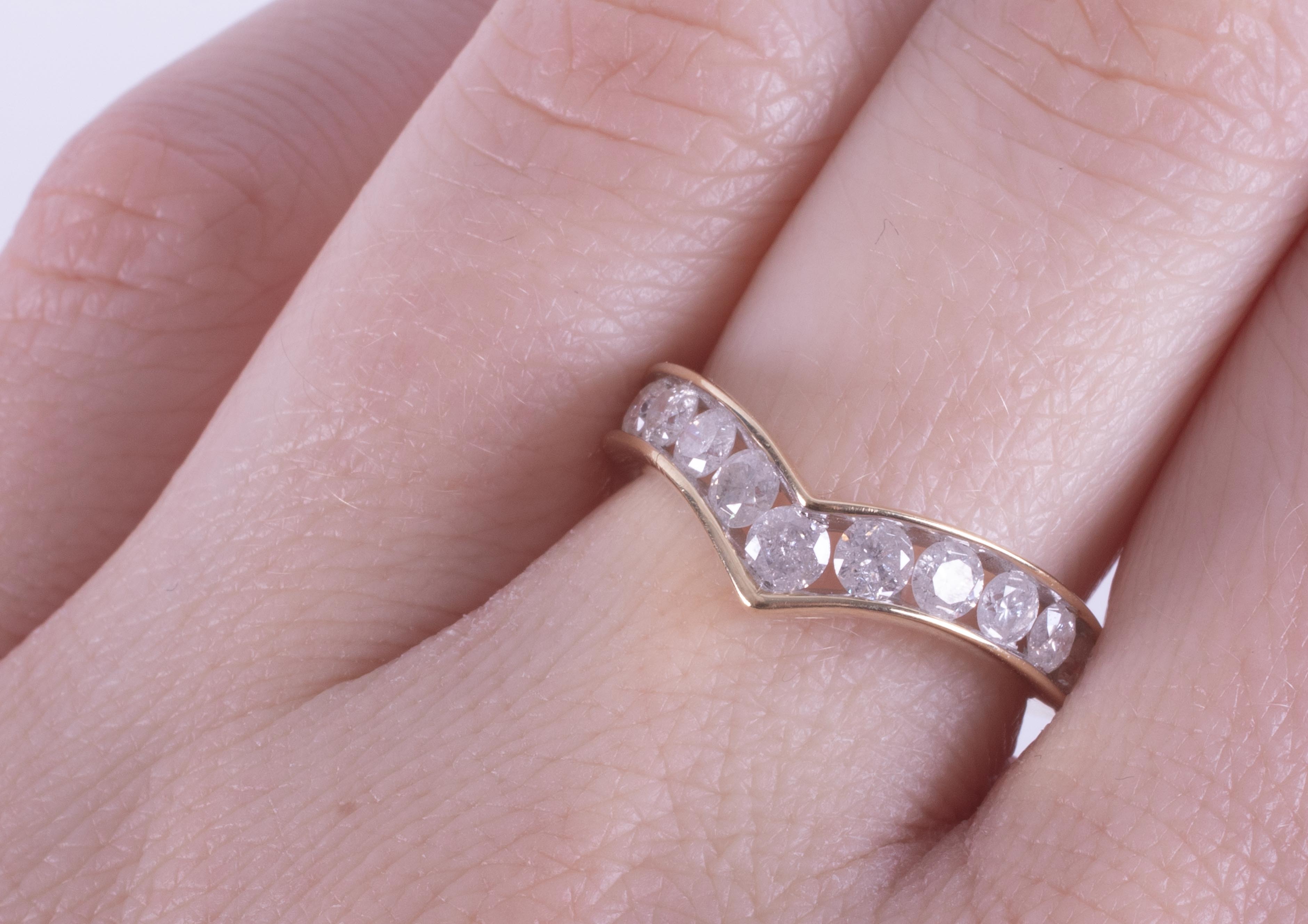 A 9ct yellow gold wishbone ring set with eleven round brilliant cut diamonds, approx. 1.10 carats - Image 2 of 2