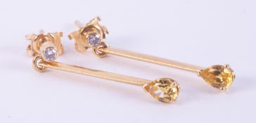 A pair of 18ct yellow gold drop bar earrings set with a round brilliant cut diamond to the top,