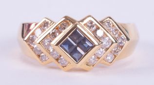 An 18ct yellow gold ring set centrally with four princess cut sapphires, total weight approx. 0.25