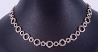 A 14ct yellow gold contemporary style 'circle' design necklace set with small round brilliant cut