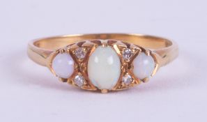 An 18ct yellow gold antique ring set with a central oval cabochon cut opal measuring approx. 55mm