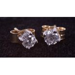 A pair of 18ct yellow & white gold stud earrings set with round brilliant cut diamonds, total weight