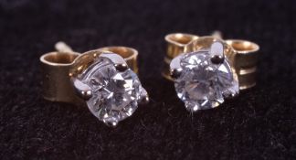 A pair of 18ct yellow & white gold stud earrings set with round brilliant cut diamonds, total weight