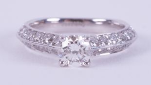 A fine platinum ring set with a central 0.40 carat round brilliant cut diamond, colour H and SI2