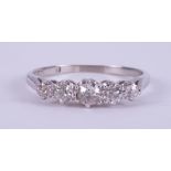 An 18ct white gold five stone ring set with five older round cut diamonds, total diamond weight