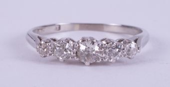 An 18ct white gold five stone ring set with five older round cut diamonds, total diamond weight