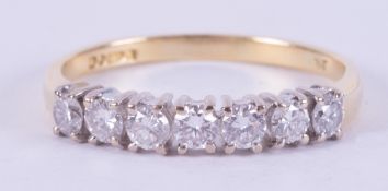 An 18ct yellow & white gold half eternity style ring set with seven round brilliant cut diamonds,