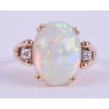 A 14ct yellow gold ring set with a central oval cabochon cut white opal, measuring approx. 15.9mm