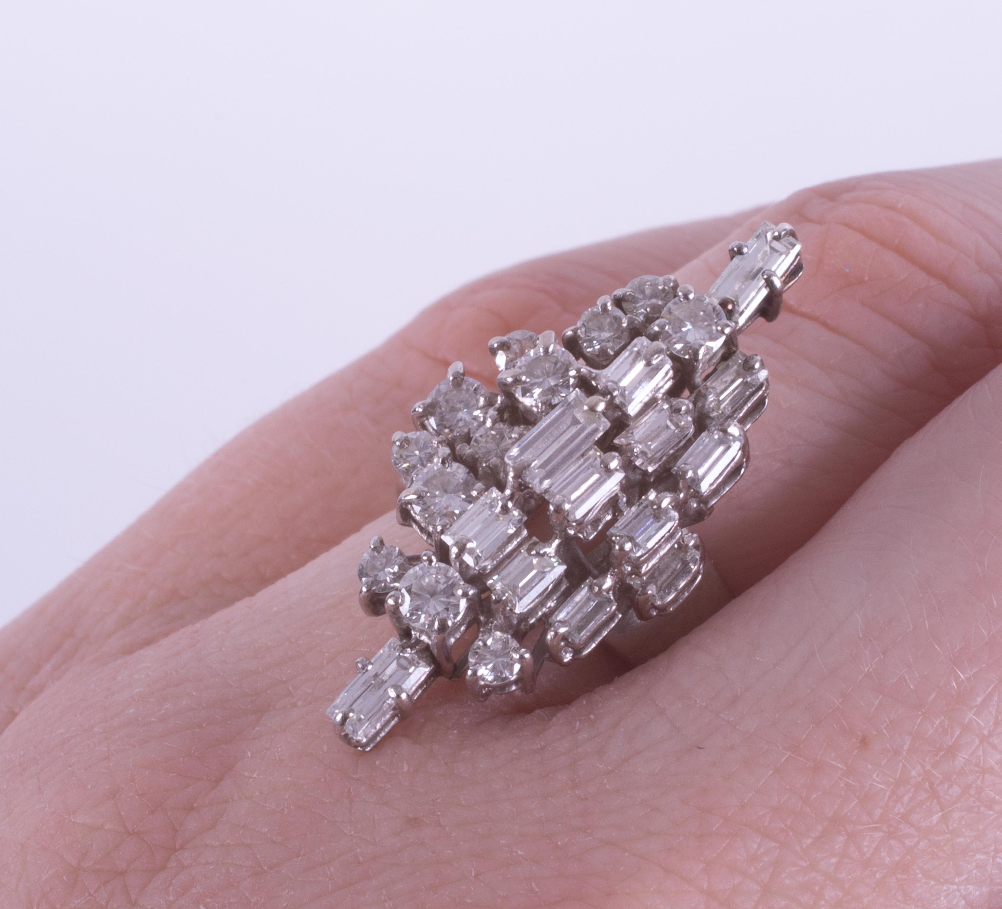An 18ct white gold ring set with a mixture of baguette cuts and round brilliant cut diamonds in a - Image 2 of 2