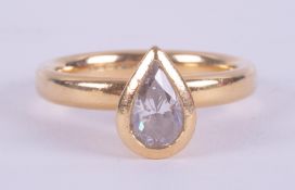 An 18ct yellow gold ring set with a pear shaped diamond in a rubover setting, approx. 0.75 carats (