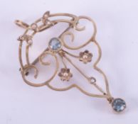 A 9ct yellow gold Art Nouveau brooch/pendant set with two round cut blue gemstones possibly