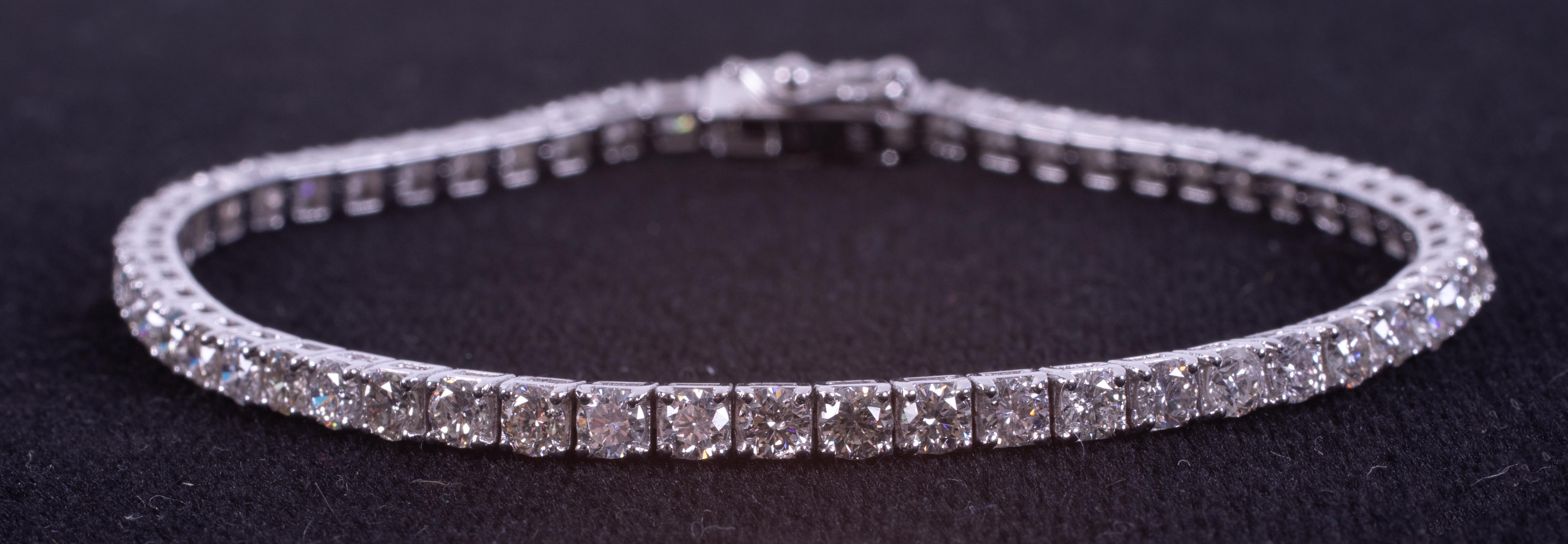 An 18ct white gold line bracelet set with approx. 5.15 carats of round brilliant cut diamonds,