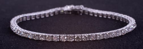 An 18ct white gold line bracelet set with approx. 5.15 carats of round brilliant cut diamonds,