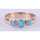 A 9ct yellow gold (not hallmarked or tested) ring set with three cabochon cut turquoise stones, 3.