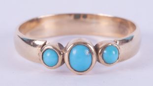 A 9ct yellow gold (not hallmarked or tested) ring set with three cabochon cut turquoise stones, 3.