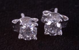 A pair of 18ct white gold four claw solitaire earrings set with a total of 0.59 carats of round