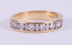 An 18ct yellow gold half eternity ring set with alternating baguette cut & round cut diamonds, the