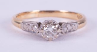 An 18ct yellow gold & platinum ring set with a single central set round cut diamond, approx. 0.10