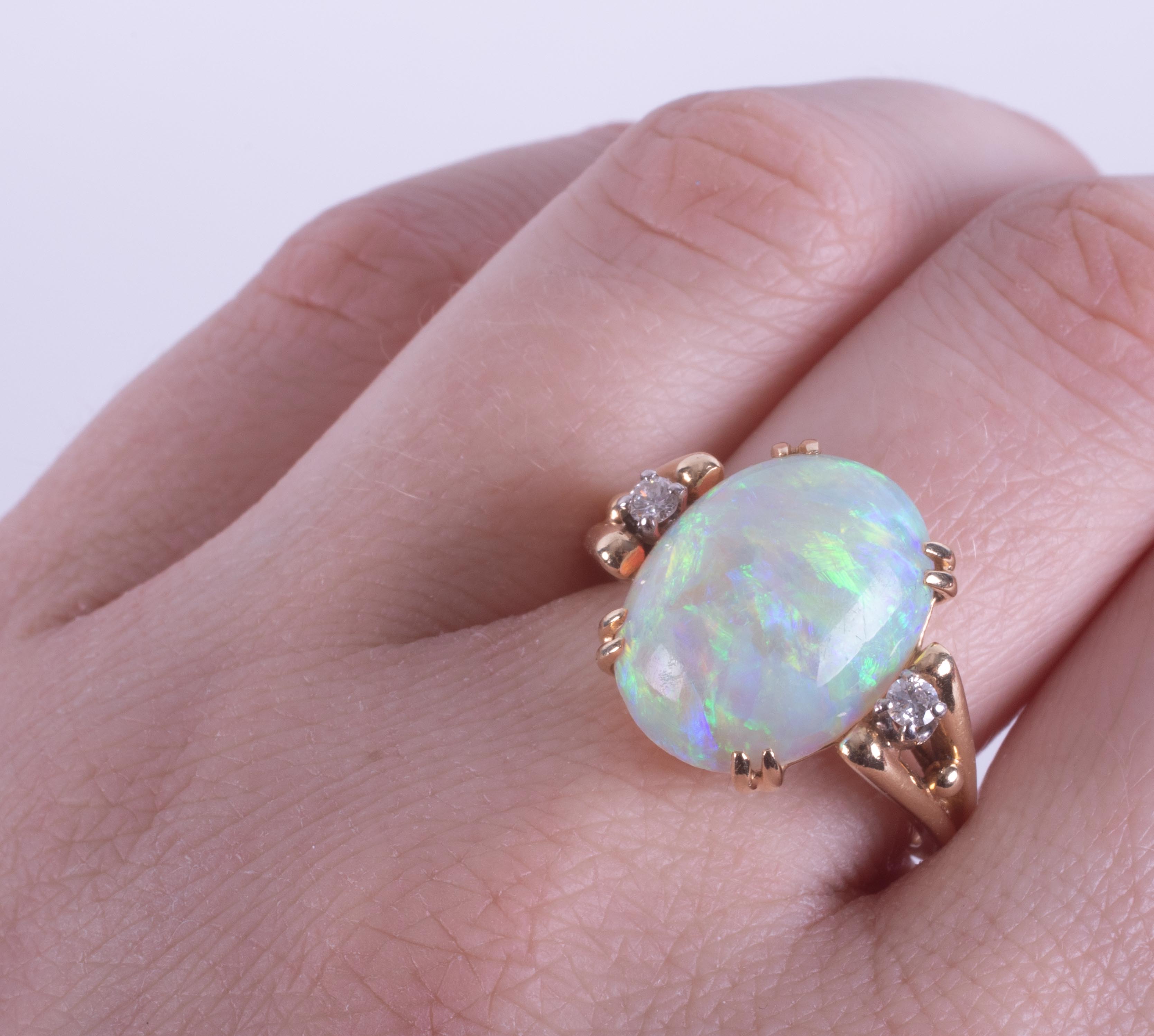 A 14ct yellow gold ring set with a central oval cabochon cut white opal, measuring approx. 15.9mm - Image 2 of 2