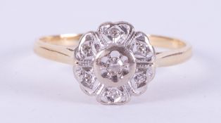 An 18ct yellow & white gold flower ring set with small round cut diamonds, approx. total diamond