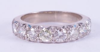 An 18ct white gold half eternity style ring set with eight round brilliant cut diamonds, approx.