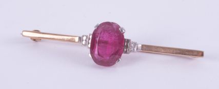 A yellow & white gold bar brooch (no hallmarks and not tested) set centrally with an oval cut pink