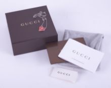 A silver & enamelled Gucci heart necklace with the Gucci logo in the chain as well as on the