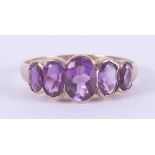 A 9ct yellow gold five stone ring set with oval cut amethysts, total weight approx. 1.83 carats (