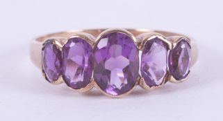 A 9ct yellow gold five stone ring set with oval cut amethysts, total weight approx. 1.83 carats (