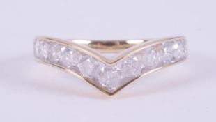 A 9ct yellow gold wishbone ring set with eleven round brilliant cut diamonds, approx. 1.10 carats